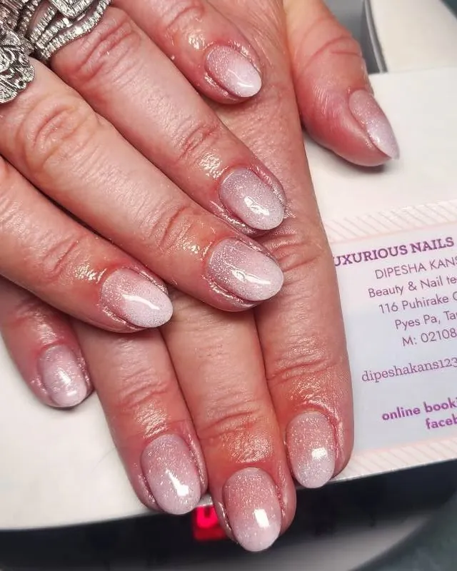 Close up of soft pink pearl gel nails with a fine shimmer